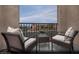 Relaxing covered balcony with comfortable seating offering views of the quiet neighborhood at 5761 Crenellated St # Lot 60, Las Vegas, NV 89148