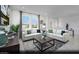 Bright living room with two sofas, large windows, neutral color palette, and modern decor at 5761 Crenellated St # Lot 60, Las Vegas, NV 89148