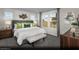 Cozy main bedroom with large windows, carpeted floors, accent wall art, and neutral tones at 5761 Crenellated St # Lot 60, Las Vegas, NV 89148