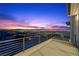 A spacious balcony with stunning views of the city skyline at twilight at 577 Overlook Rim Dr, Henderson, NV 89012