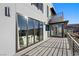 Modern home's outdoor balcony featuring large sliding glass doors and contemporary railings at 577 Overlook Rim Dr, Henderson, NV 89012