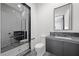 Modern bathroom with glass shower, dark gray cabinets, and hexagon tiled floors at 577 Overlook Rim Dr, Henderson, NV 89012