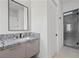 Modern bathroom with a granite vanity, sleek fixtures, and a glass-enclosed shower at 577 Overlook Rim Dr, Henderson, NV 89012