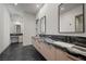 Modern bathroom features double sinks, stylish fixtures, and black marble countertops for a luxurious feel at 577 Overlook Rim Dr, Henderson, NV 89012