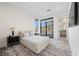 Bright bedroom with a platform bed, modern decor, and scenic outdoor views at 577 Overlook Rim Dr, Henderson, NV 89012