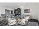 Dining room with modern lighting, adjacent to the kitchen and breakfast bar at 577 Overlook Rim Dr, Henderson, NV 89012