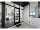Modern entryway with black marble floors, glass doors, and staircase showcases contemporary design at 577 Overlook Rim Dr, Henderson, NV 89012