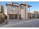 Modern two-story home with clean lines, balcony, and desert landscaping on a paved driveway at 577 Overlook Rim Dr, Henderson, NV 89012