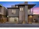Contemporary home with clean lines, modern garage door, and desert landscaping for curb appeal at 577 Overlook Rim Dr, Henderson, NV 89012