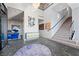 Grand foyer with modern art, staircase, and open floor plan at 577 Overlook Rim Dr, Henderson, NV 89012