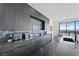 The kitchen features sleek gray cabinets and stainless steel appliances at 577 Overlook Rim Dr, Henderson, NV 89012