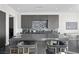 Open kitchen boasts gray cabinets, granite countertops, and island seating at 577 Overlook Rim Dr, Henderson, NV 89012