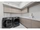 Well-equipped laundry room with modern appliances, ample cabinetry, and a sleek sink at 577 Overlook Rim Dr, Henderson, NV 89012