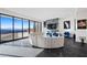 Modern living room with a unique round sofa and beautiful city view at 577 Overlook Rim Dr, Henderson, NV 89012