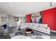 Spacious living room with large white sectional sofa and colorful art wall at 577 Overlook Rim Dr, Henderson, NV 89012