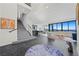 Spacious living area with modern decor, stylish staircase, and stunning views from expansive windows at 577 Overlook Rim Dr, Henderson, NV 89012