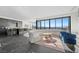 Open-concept living room features modern decor, floor-to-ceiling windows, and a stylish kitchen at 577 Overlook Rim Dr, Henderson, NV 89012