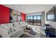 Spacious living room with vibrant art, plush seating, and sliding glass doors with scenic views at 577 Overlook Rim Dr, Henderson, NV 89012