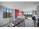 Bright living room boasts floor-to-ceiling windows, modern design, and stylish blue velvet barstools at 577 Overlook Rim Dr, Henderson, NV 89012