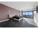 Modern bedroom with a large glass window overlooking a beautiful landscape and black marble floors at 577 Overlook Rim Dr, Henderson, NV 89012