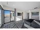 Modern bedroom with black marble floors and sliding glass doors that lead to a deck at 577 Overlook Rim Dr, Henderson, NV 89012
