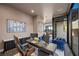 Home office with a modern desk, blue chair, and views of the outdoors at 577 Overlook Rim Dr, Henderson, NV 89012