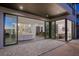 Spacious patio with open access to a modern living room, dining area, and staircase at 577 Overlook Rim Dr, Henderson, NV 89012