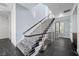 Modern staircase with metal railing and gray carpeted steps on dark marble floors at 577 Overlook Rim Dr, Henderson, NV 89012