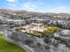 A beautifully landscaped backyard featuring a sparkling pool is on display in this modern home, set against a backdrop of mountains at 584 Saint Croix St, Henderson, NV 89012