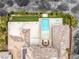 Aerial view highlighting a luxury home's private backyard with a pool, spa, patio furniture and meticulously manicured landscaping at 584 Saint Croix St, Henderson, NV 89012