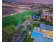Aerial view showcasing a luxury property with a pool, adjacent to a lush golf course and community at 584 Saint Croix St, Henderson, NV 89012