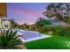 Stunning backyard pool and spa with beautiful landscaping and an inviting ambiance during twilight at 584 Saint Croix St, Henderson, NV 89012