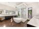 This bathroom features an elegant soaking tub, a glass-enclosed shower, and dual sinks at 584 Saint Croix St, Henderson, NV 89012
