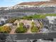 Monochrome aerial view highlighting the luxurious home, scenic mountain backdrop, and lush neighborhood at 584 Saint Croix St, Henderson, NV 89012