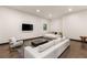 Open-concept living area with sleek furnishings, a large TV, and a comfortable white sofa at 584 Saint Croix St, Henderson, NV 89012