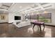 Bright living room with a pool table and large windows offering scenic views at 584 Saint Croix St, Henderson, NV 89012
