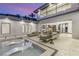 Luxury outdoor living area with lounge seating next to tanning ledge, perfect for relaxation and social gatherings at 584 Saint Croix St, Henderson, NV 89012