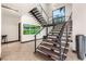 Modern staircase design with wood steps, metal railings and unique green wall art at 584 Saint Croix St, Henderson, NV 89012