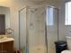 Bathroom featuring a walk-in shower with glass enclosure, single sink vanity and neutral tile flooring at 6086 Sunken River Trl, Las Vegas, NV 89118
