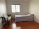Bedroom featuring wood-look floors, a window and a full sized bed at 6086 Sunken River Trl, Las Vegas, NV 89118