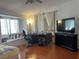 Bedroom featuring a window seat and dark wood-look floors plus a black desk and dresser at 6086 Sunken River Trl, Las Vegas, NV 89118