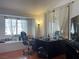 Bedroom featuring a window seat and dark wood-look floors plus a black desk and dresser at 6086 Sunken River Trl, Las Vegas, NV 89118