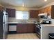 Traditional kitchen featuring wooden cabinets, stainless steel appliances, and ample counter space at 6086 Sunken River Trl, Las Vegas, NV 89118
