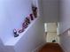 View of a staircase with wood treads and a decorative ledge that leads to a landing at 6086 Sunken River Trl, Las Vegas, NV 89118
