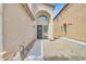 Inviting entryway with arched alcove, decorative door wreath, and low-maintenance desert landscaping at 6717 Lincoln Wood St, Las Vegas, NV 89149
