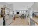 Well-equipped kitchen with stainless steel refrigerator and an open view into the dining and living areas at 6717 Lincoln Wood St, Las Vegas, NV 89149