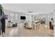 Bright, open-concept living area with travertine flooring, neutral decor, and ample natural light at 6717 Lincoln Wood St, Las Vegas, NV 89149