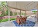 Charming patio with string lights, outdoor dining set, and a comfortable seating area for relaxing and enjoying the outdoors at 6717 Lincoln Wood St, Las Vegas, NV 89149