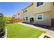 Backyard featuring artificial turf and brick-paved patio at 6730 Pivot Point St, Las Vegas, NV 89148