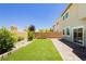Backyard featuring artificial turf and brick-paved patio at 6730 Pivot Point St, Las Vegas, NV 89148